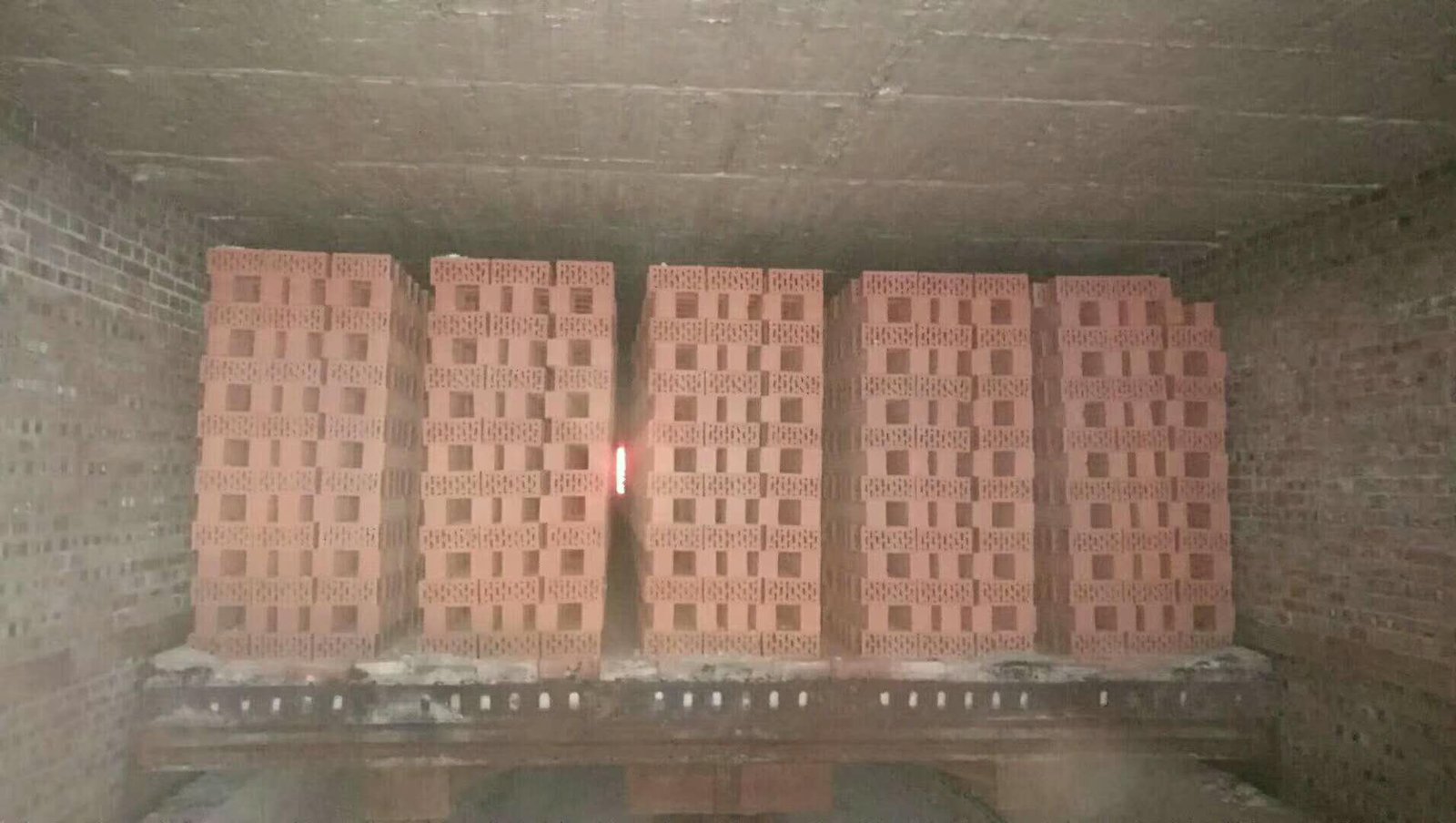 Tunnel kiln cars with refractory lining loaded with green bricks